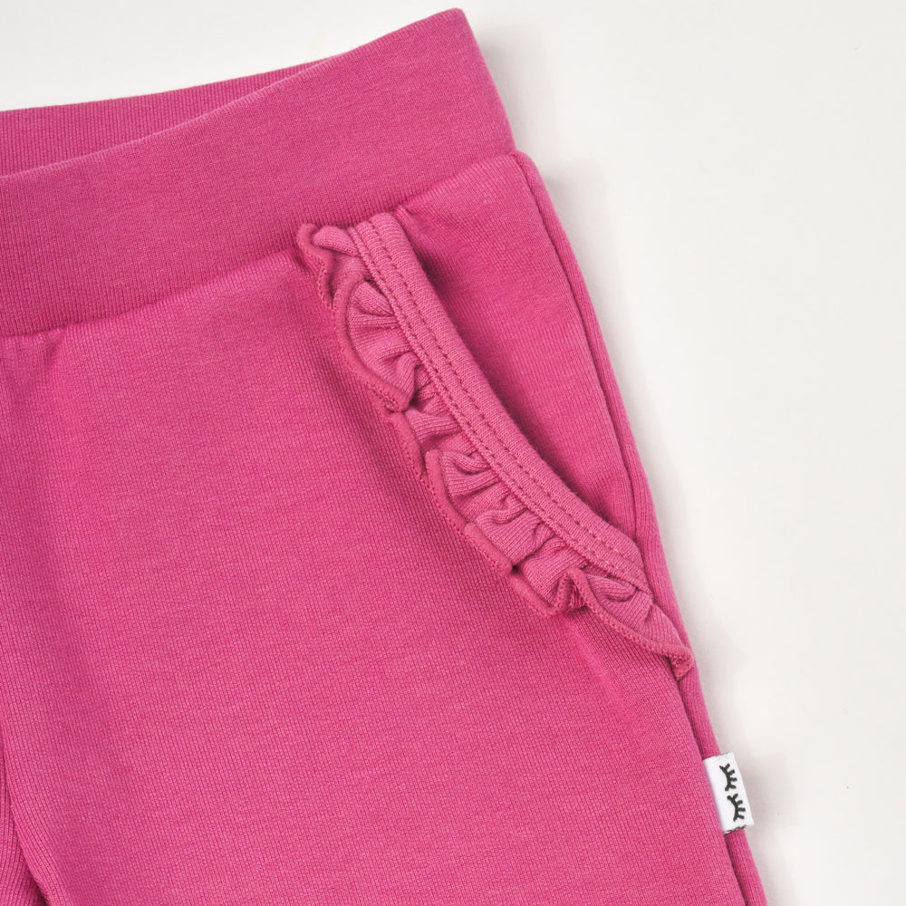 Close up flat lay image of Berry Rose Ruffle Jogger, detailing the pocket.