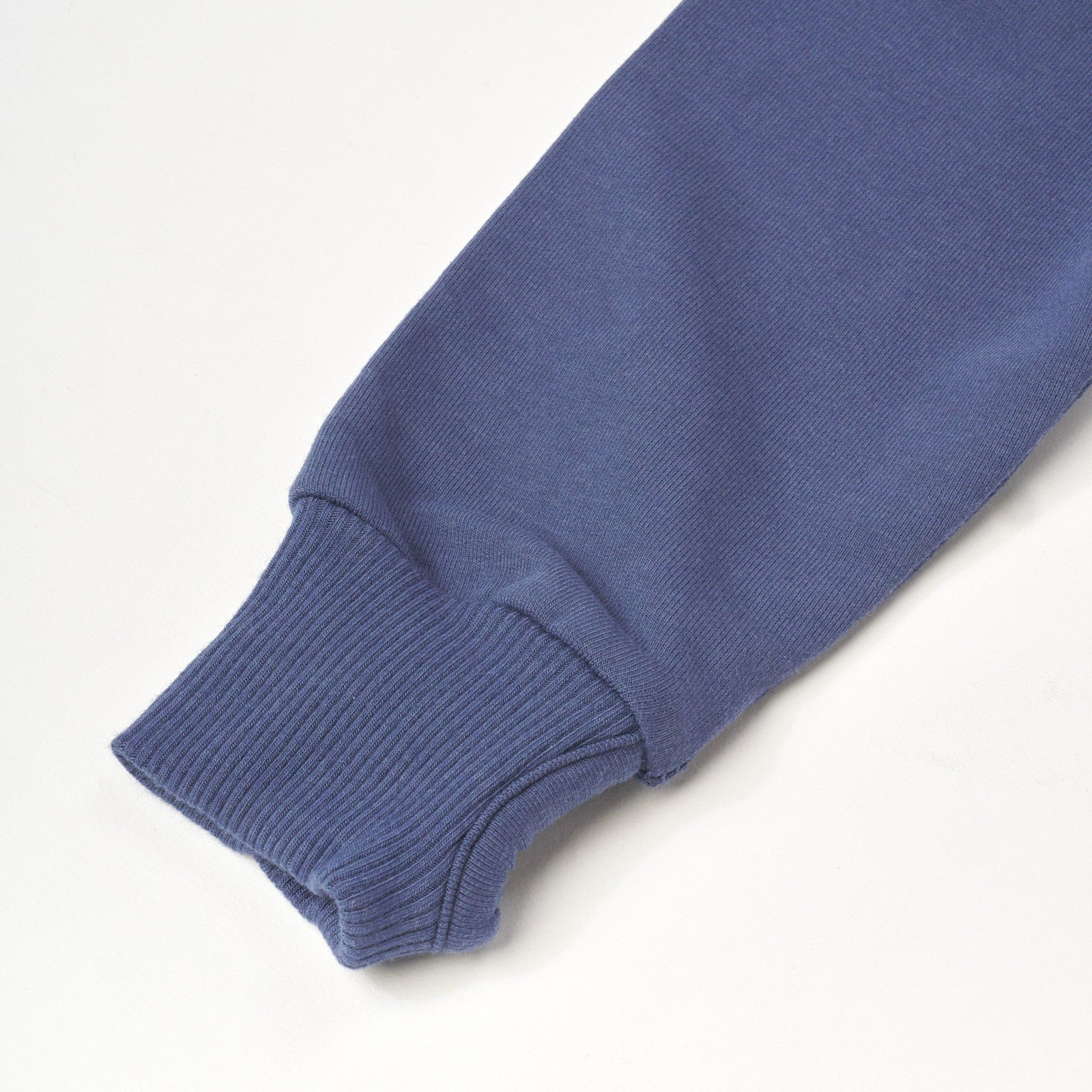 Close up flat lay image of Vintage Navy Henley Hoodie detailing the thumbhole on the sleeve cuff