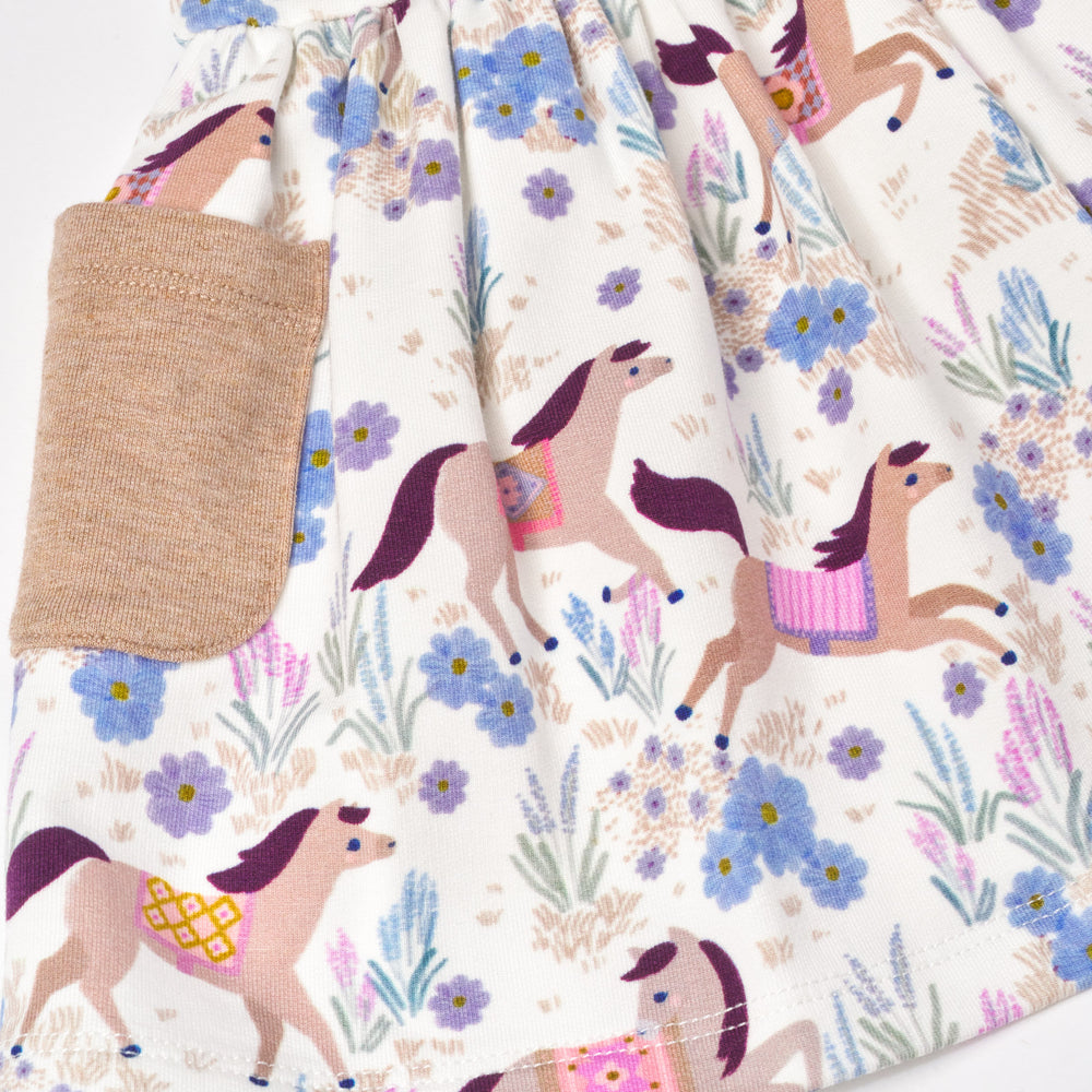 Close up flat lay image of Wildflower Ride Patch Pocket Dress with Bloomer detailing the pocket