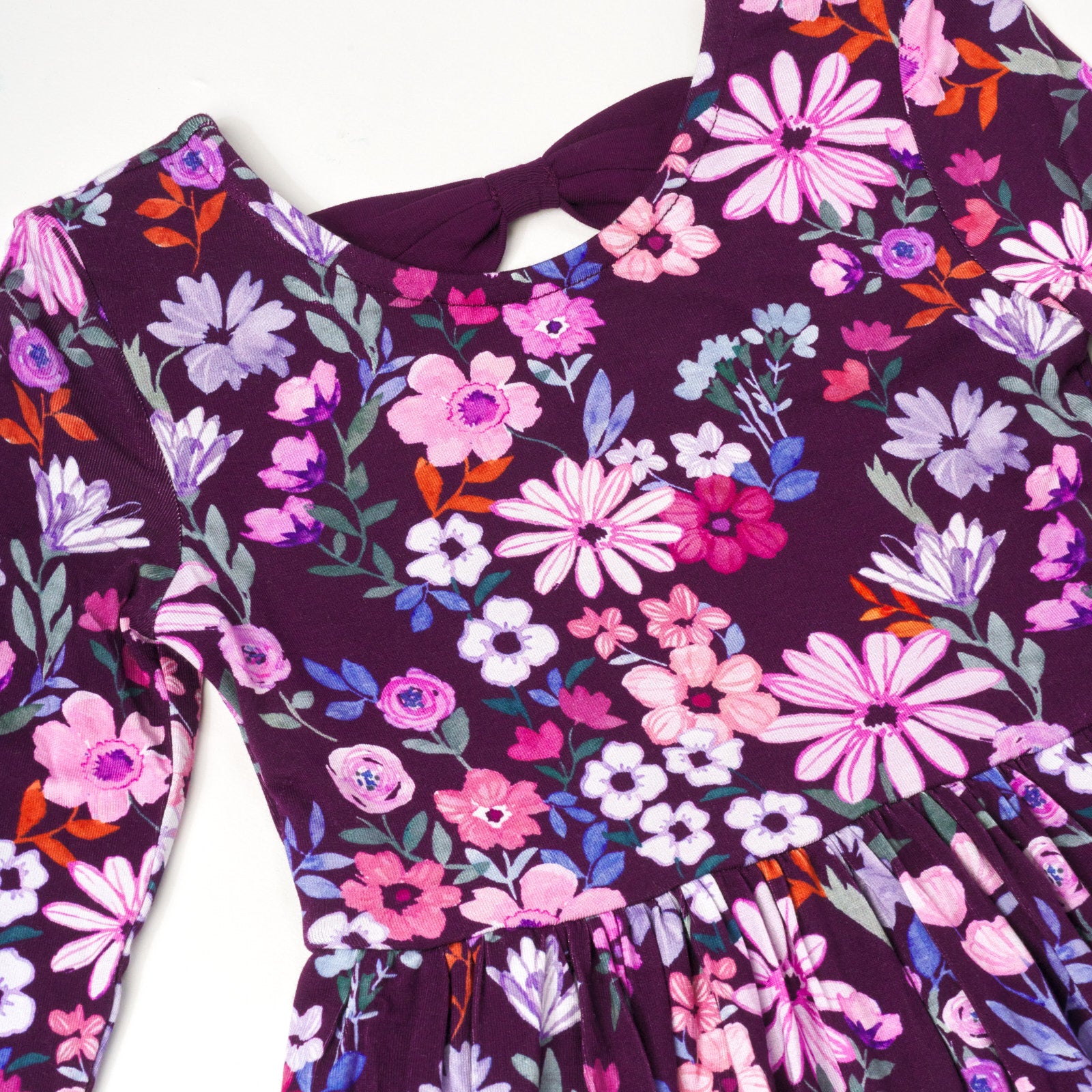 Close up flat lay image of Violet Meadow Bow Back Skater Dress