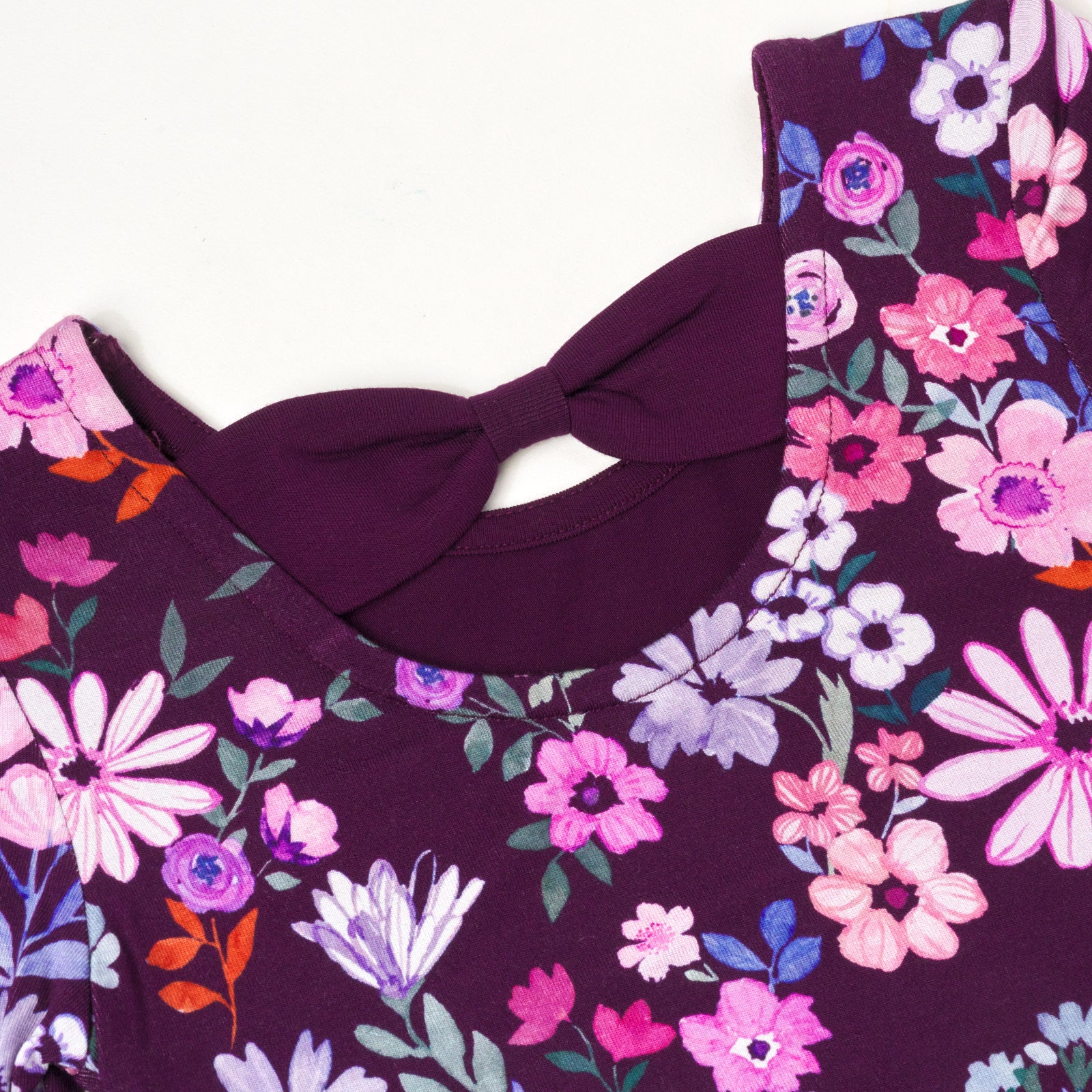 Close up flat lay image of Violet Meadow Bow Back Skater Dress detailing the bow