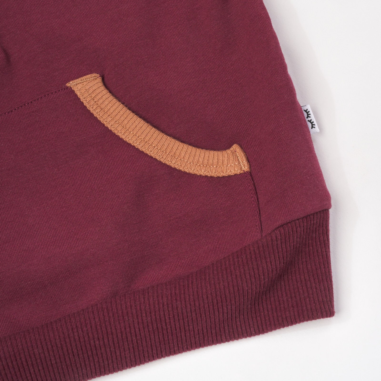 Close up flat lay image of Classic Burgundy Henley Hoodie detailing the front pocket