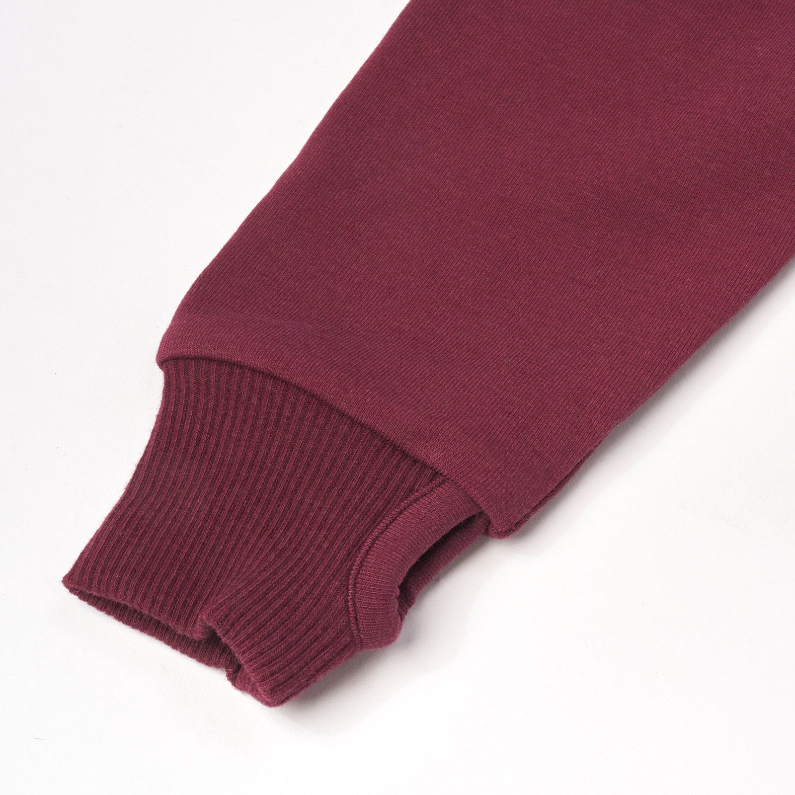 Close up flat lay image of Classic Burgundy Henley Hoodie detailing the thumbhole on the sleeve cuff