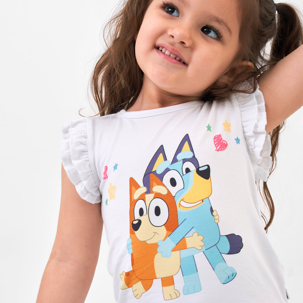 Close up image of a child wearing a Bluey graphic flutter tee