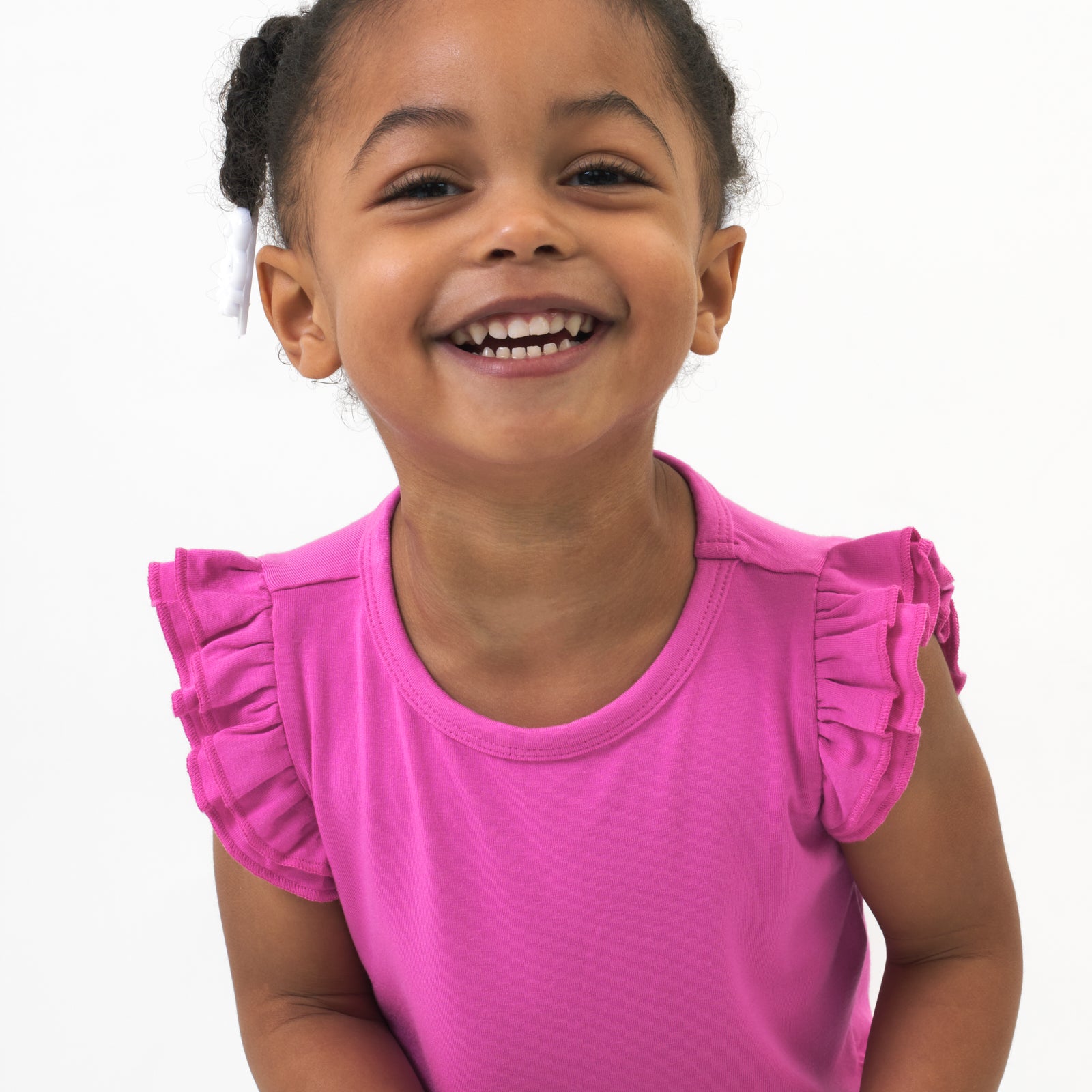 Close up image of a child posing wearing a Rouge Pink Flutter Tee 