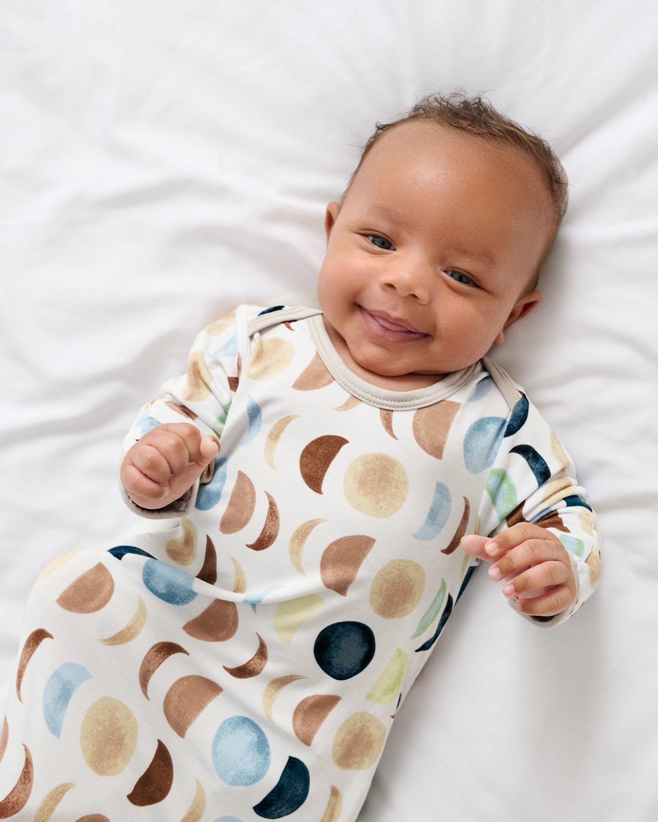 Close up of newborn in the Luna Neutral Infant Gown