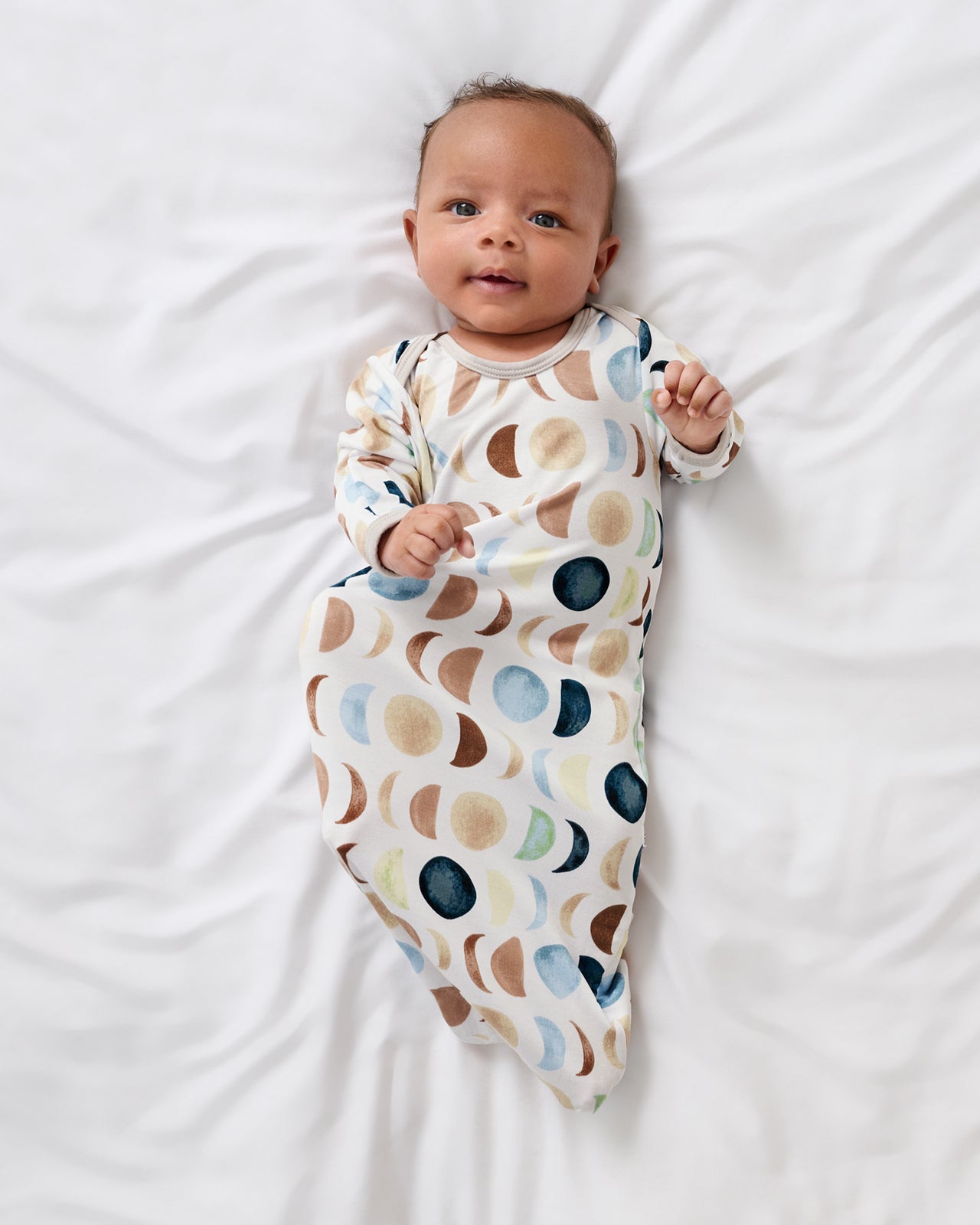 Aerial view of newborn in the Luna Neutral Infant Gown