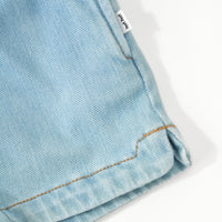 Close up image for the seam detail on the bottom and pocket of the Light Blue Denim Shorts