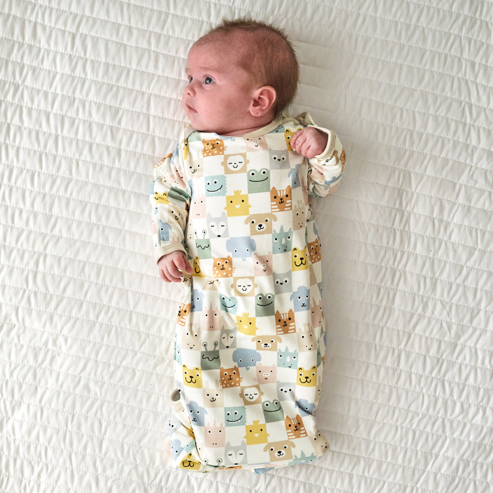 Infant laying on a blanket in a Check Mates Infant Gown