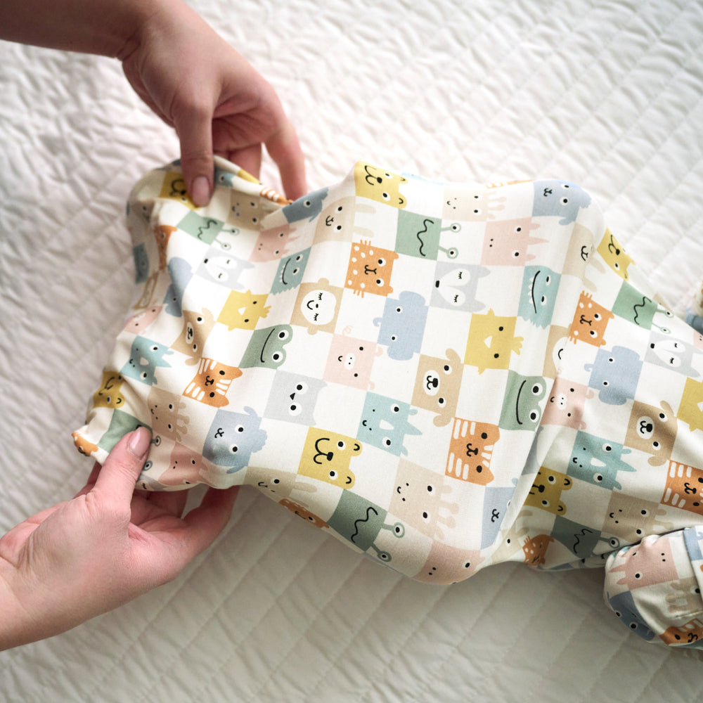 Close up image of a parent putting a Check Mates Infant Gown on an infant