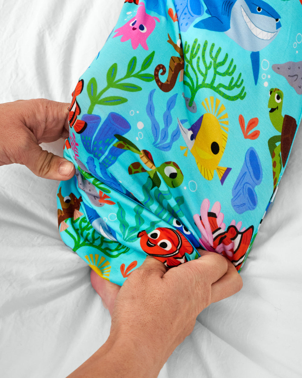 Adult demonstrating the envelop sweep on the Pixar Nemo's Reef Infant Gown