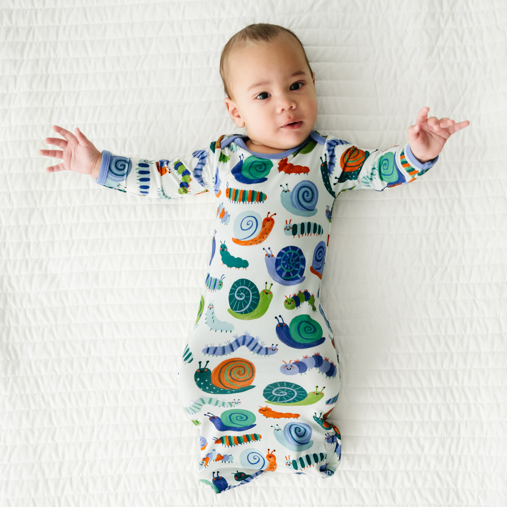 Infant laying on a blanket wearing an Inchin' Along infant gown