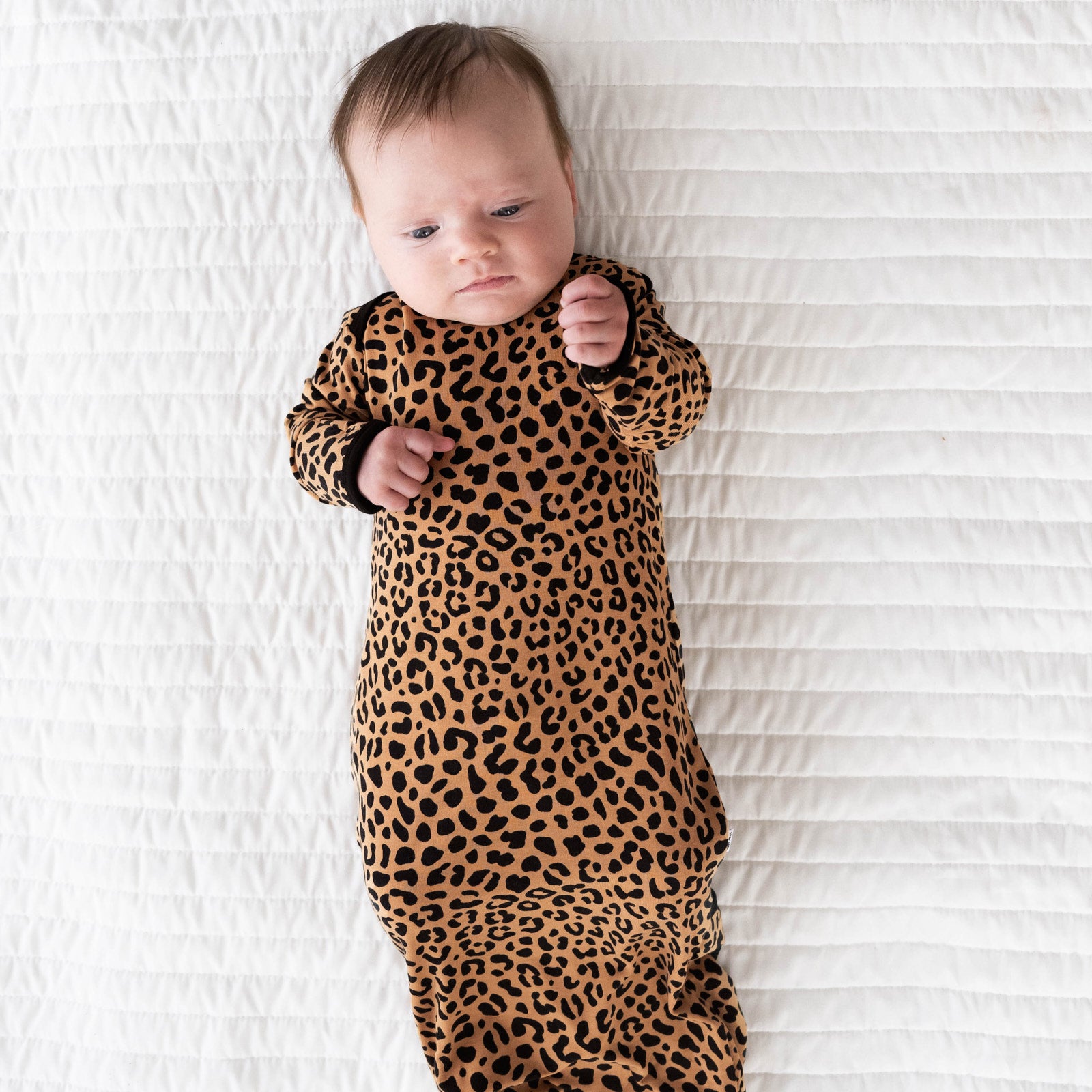 Alternative top view image of baby laying while in the Classic Leopard Infant Gown