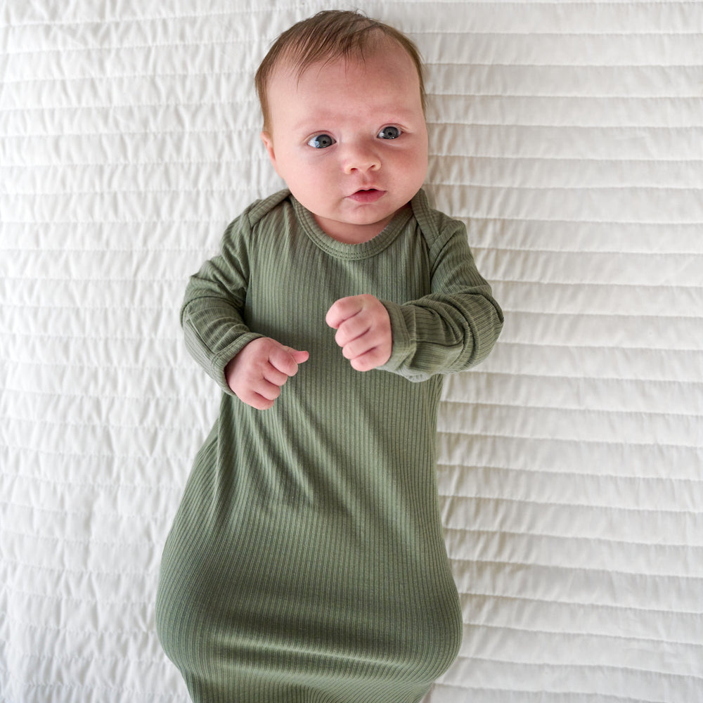 Top view image of baby laying down while in the Moss Ribbed Infant Gown