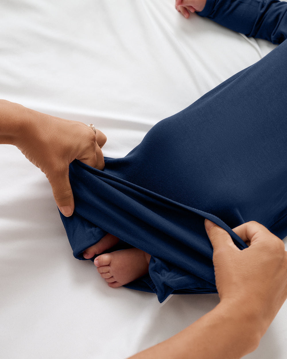 Adult demonstrating the envelope sweep on the Classic Navy Infant Gown