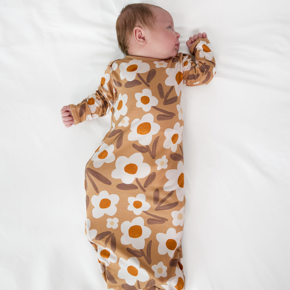 Alternate image of a child laying on a bed wearing a Daisy Daydream infant gown