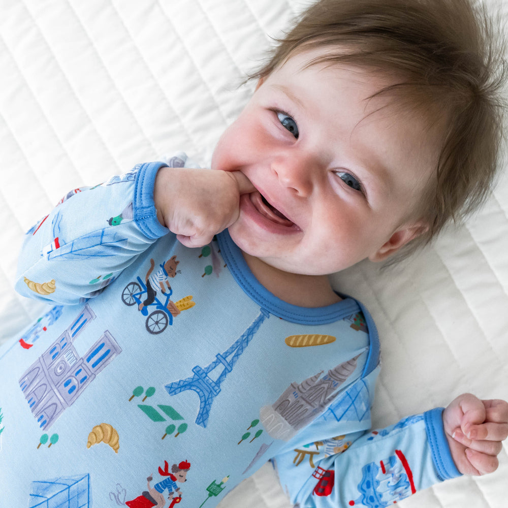 Close up image of shoulder detail on baby laying down wearing the Blue Weekend in Paris Infant Gown