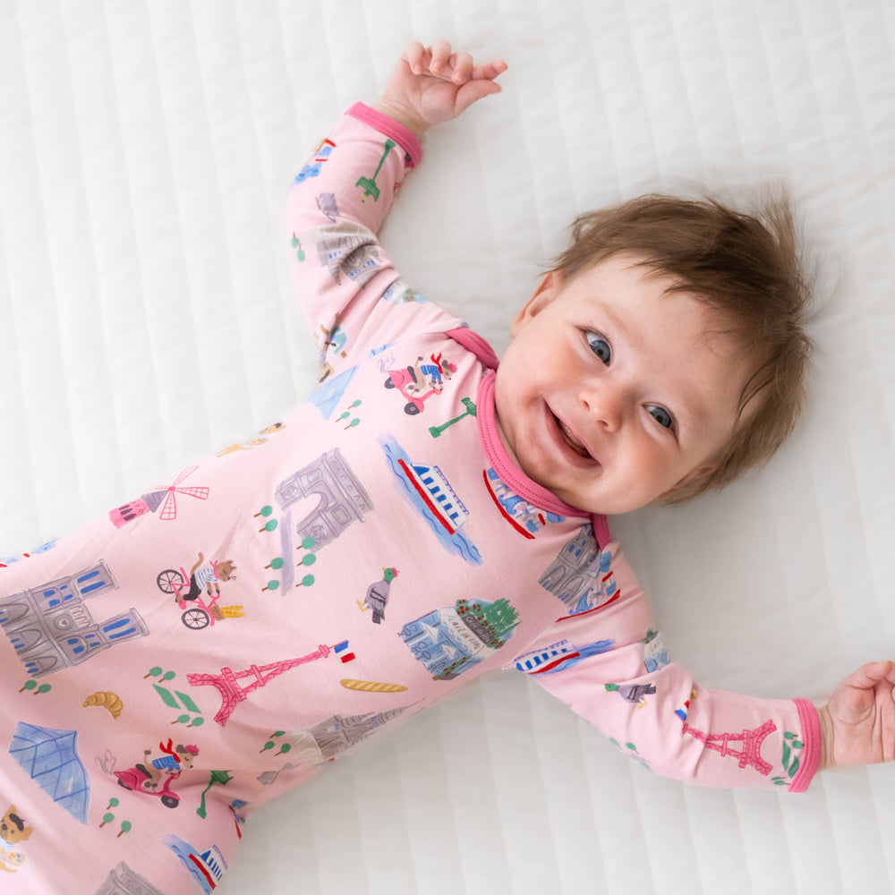 Alternative top view image of baby laying down while in the Pink Weekend in Paris Infant Gown