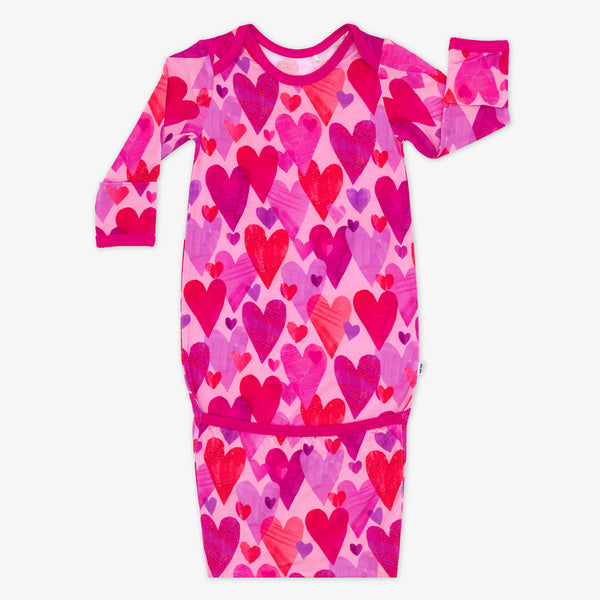 Flat lay of Pink Hearts & Crafts infant gown.