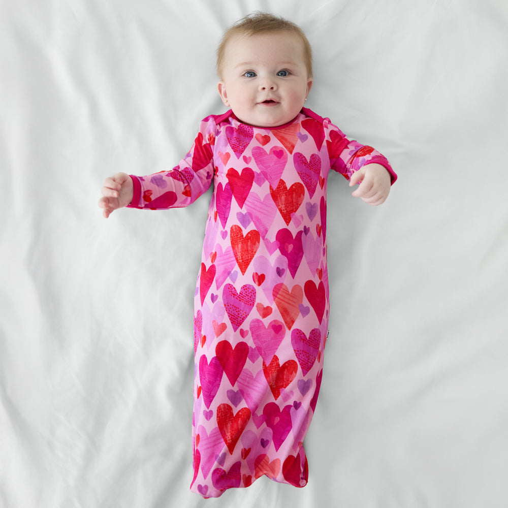 Baby wearing Pink Hearts & Crafts infant gown.