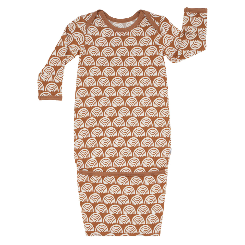 Flat lay image of a Rust Rainbows Infant Gown