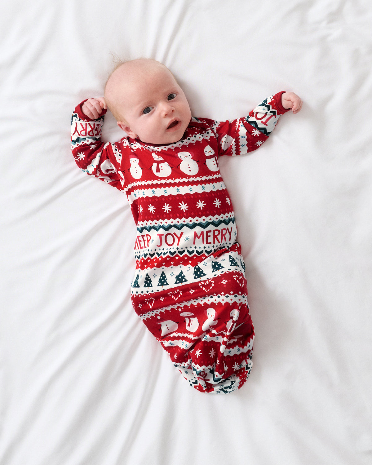 Overhead view of newborn wearing the Festive Fair Isle Infant Gown