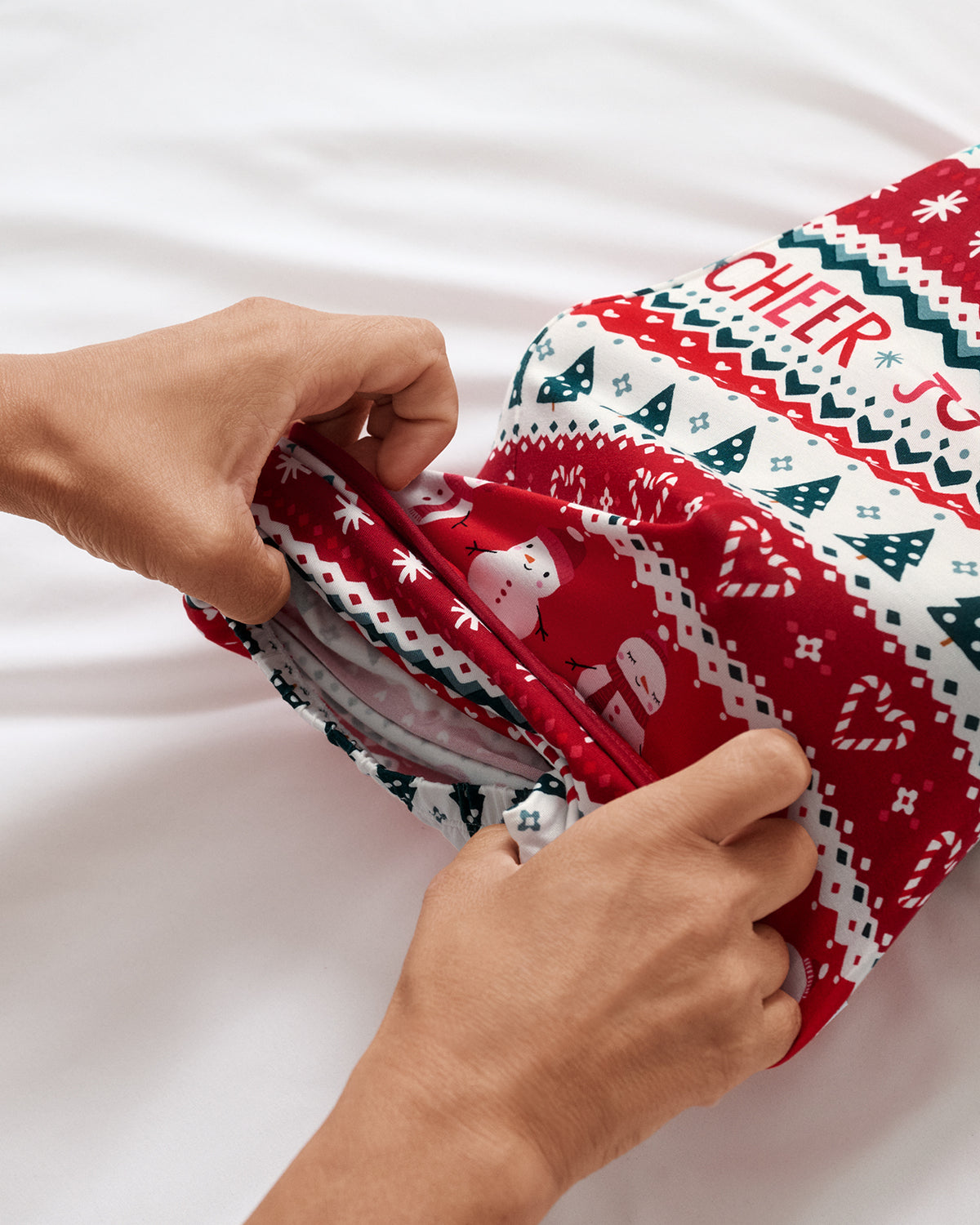 Adult demonstrating the envelope sweep on the Festive Fair Isle Infant Gown