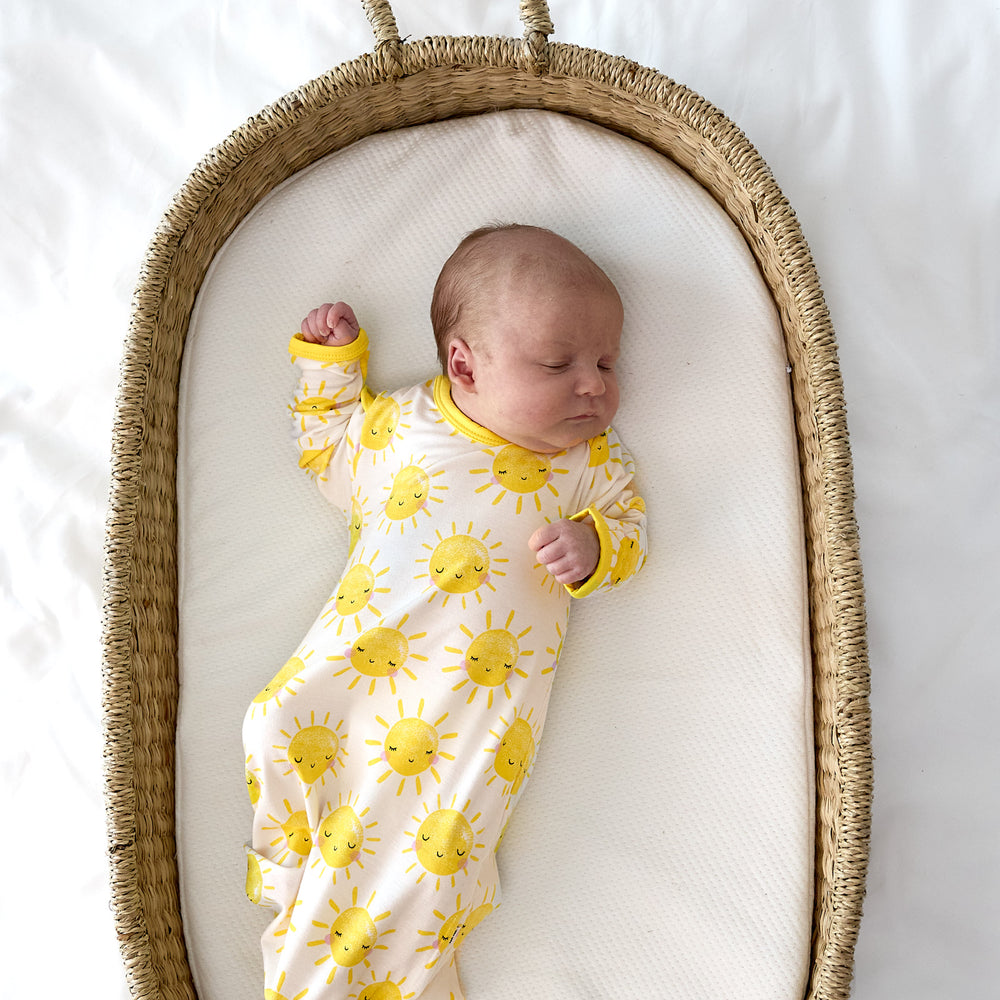 baby in basket wearing sunshine gown