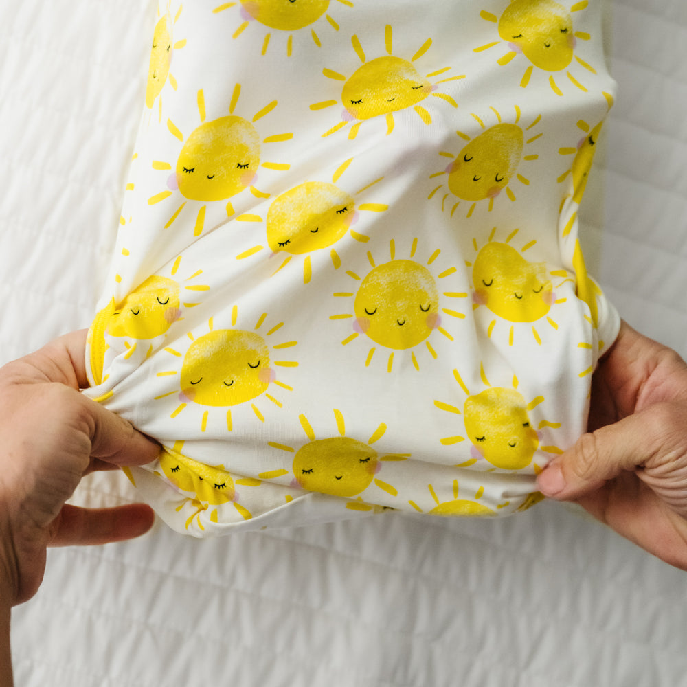 Alternate image of a child laying on a bed wearing a Sunshine Infant Gown demonstrating the fold over bottom