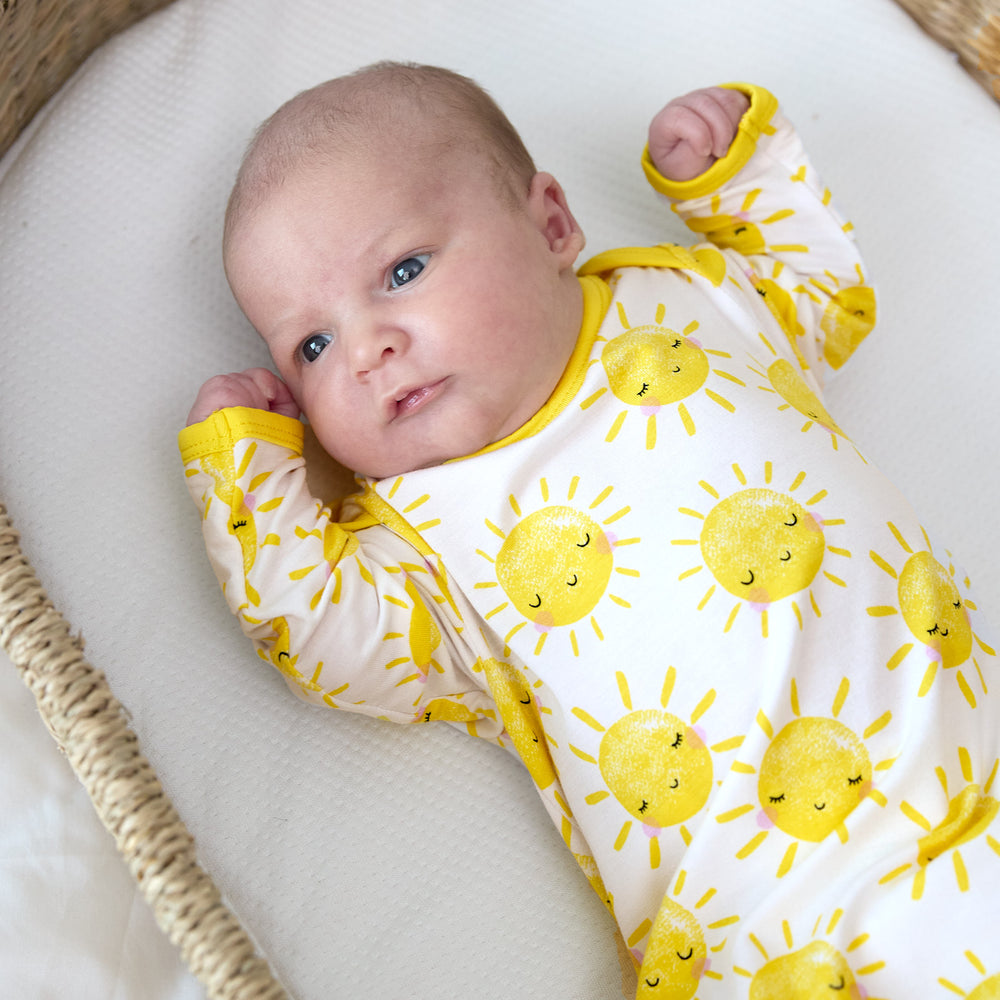 close up of baby wearing sunshine infant gown