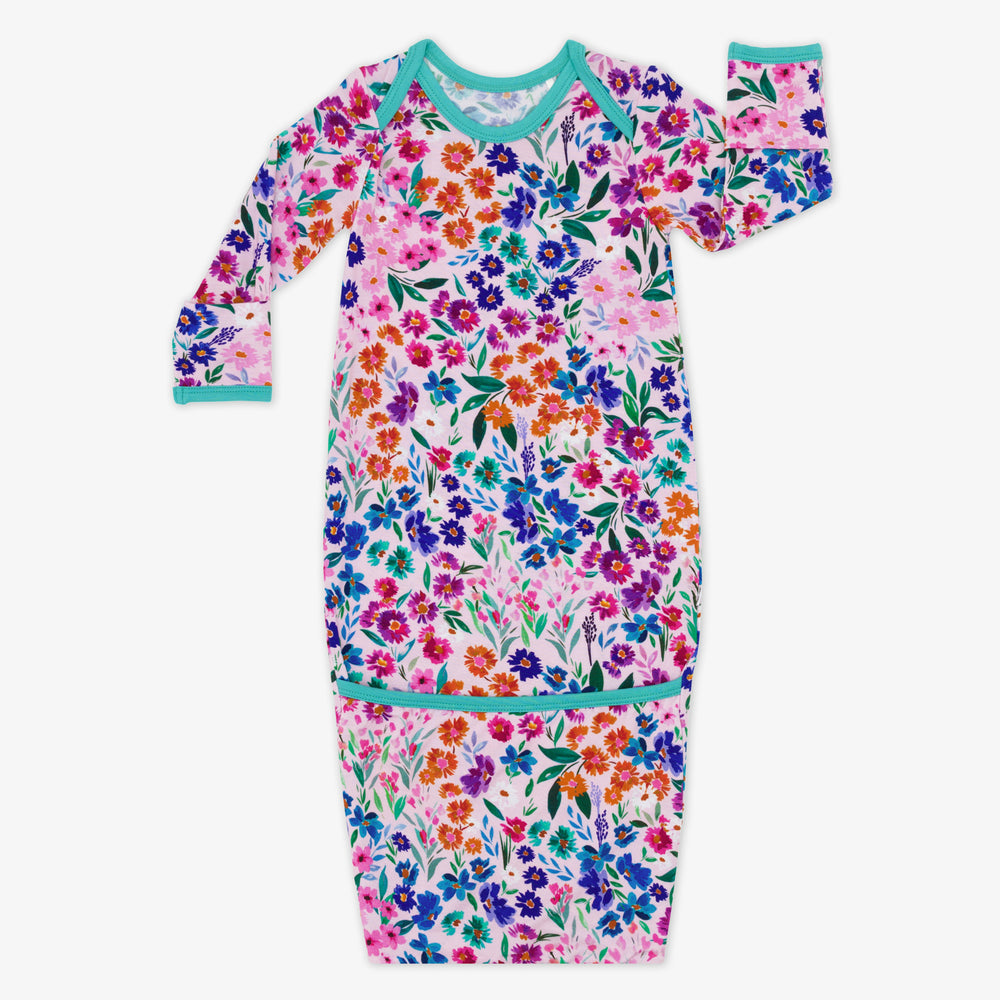 Flat lay image of a Sweet Pea Floral infant gown. 