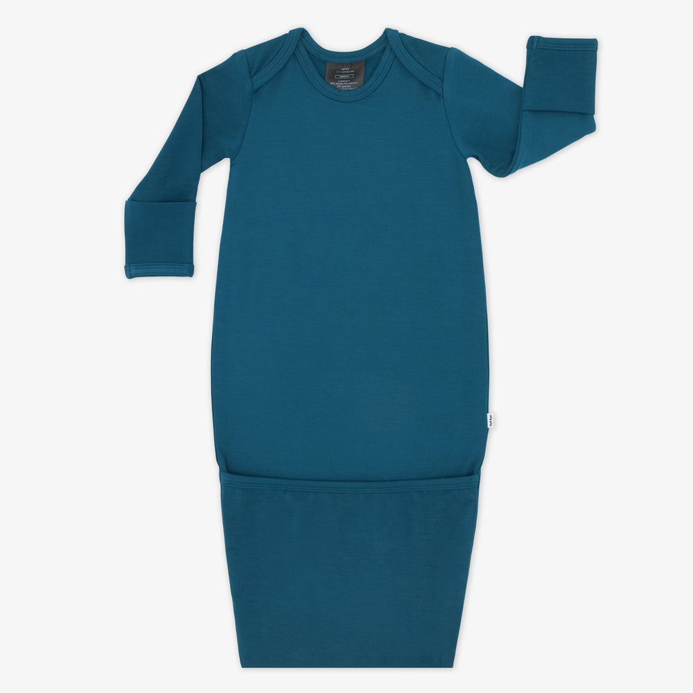 Flat lay image of a Cozy Twilight Teal infant gown