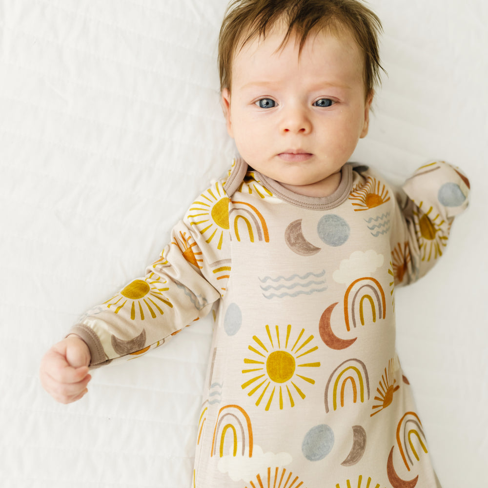 Close up image of a child wearing a Desert Sunrise infant gown