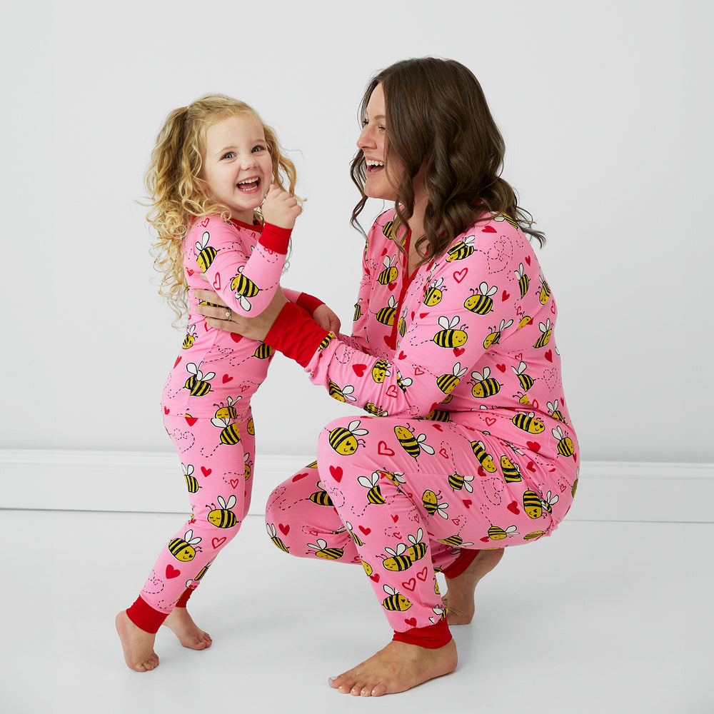 Close up image of mother and daughter wearing Pink Bee Mine pjs in women's and childrens two piece styles