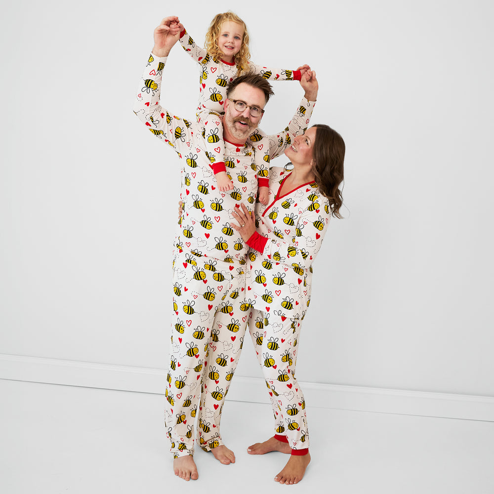 family of three wearing matching Bee Mine pjs in women's, men's, and children's two piece styles