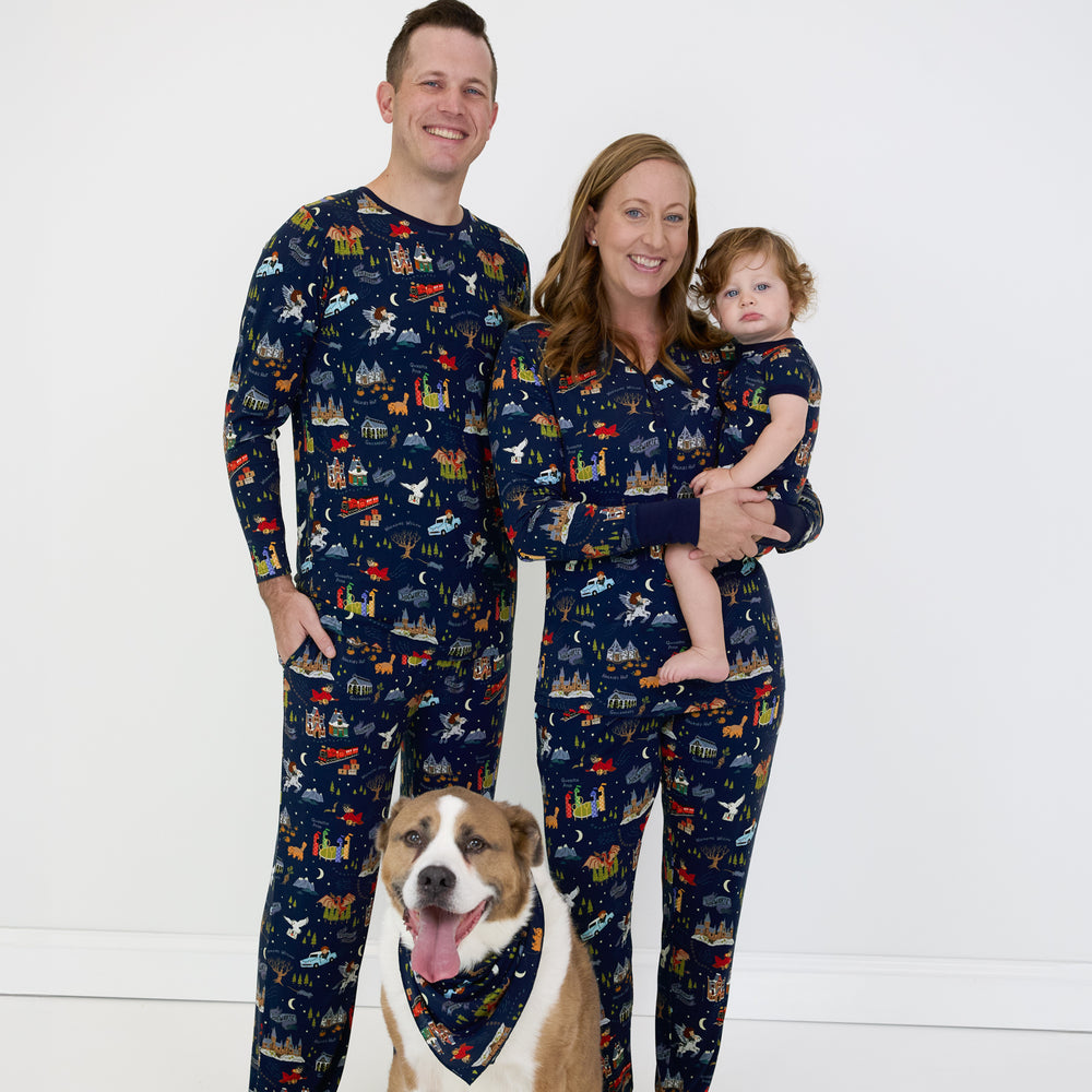 family of three and their dog wearing matching An Evening at Hogwarts printed pjs. Dad is wearing a men's pj top and men's pj pants, mom is wearing women's pj top and pj pants, and their child is wearing a shorty zippy. Their dog is wearing a matching pet bandana. 