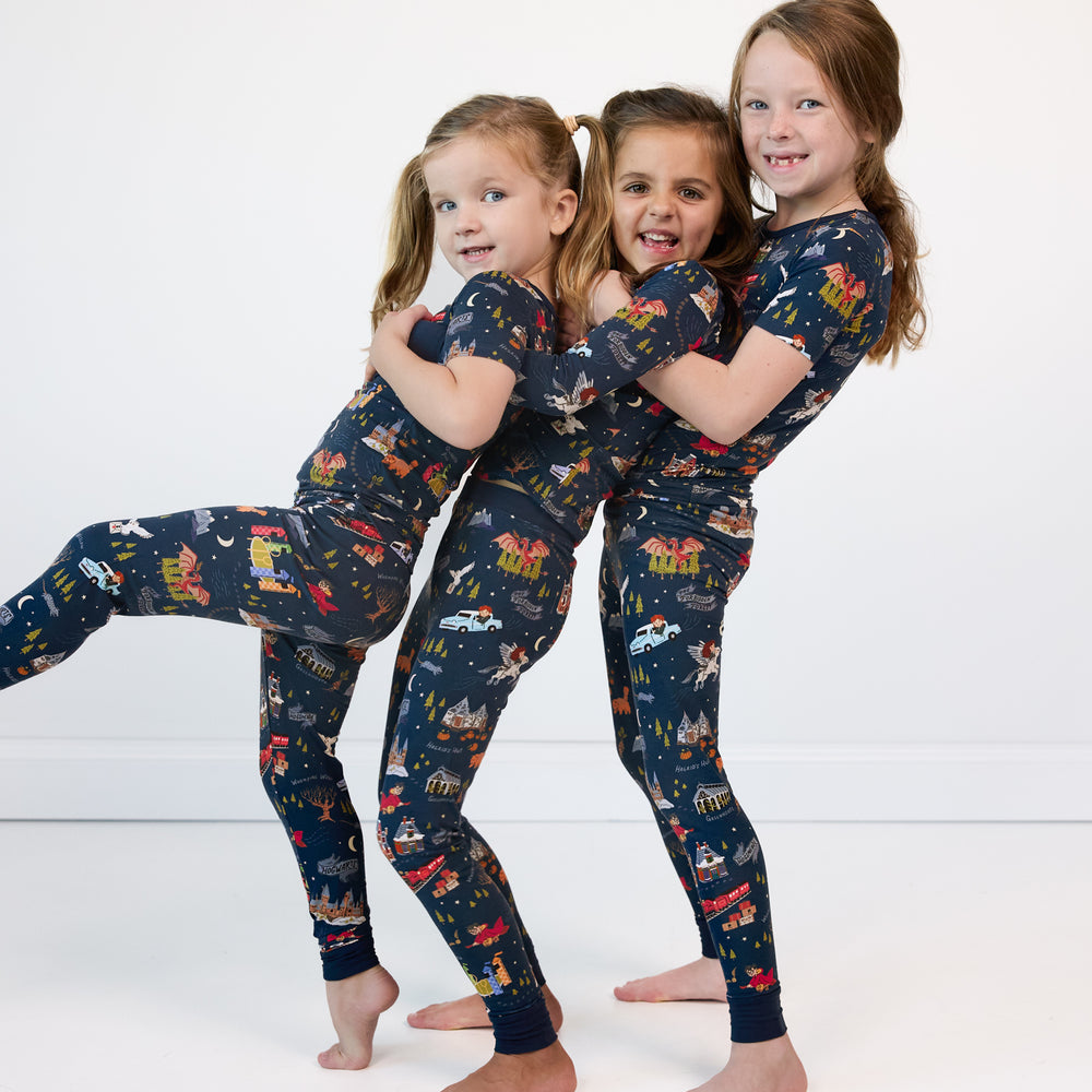 Three children posing wearing An Evening at Hogwarts two piece short sleeve pj sets