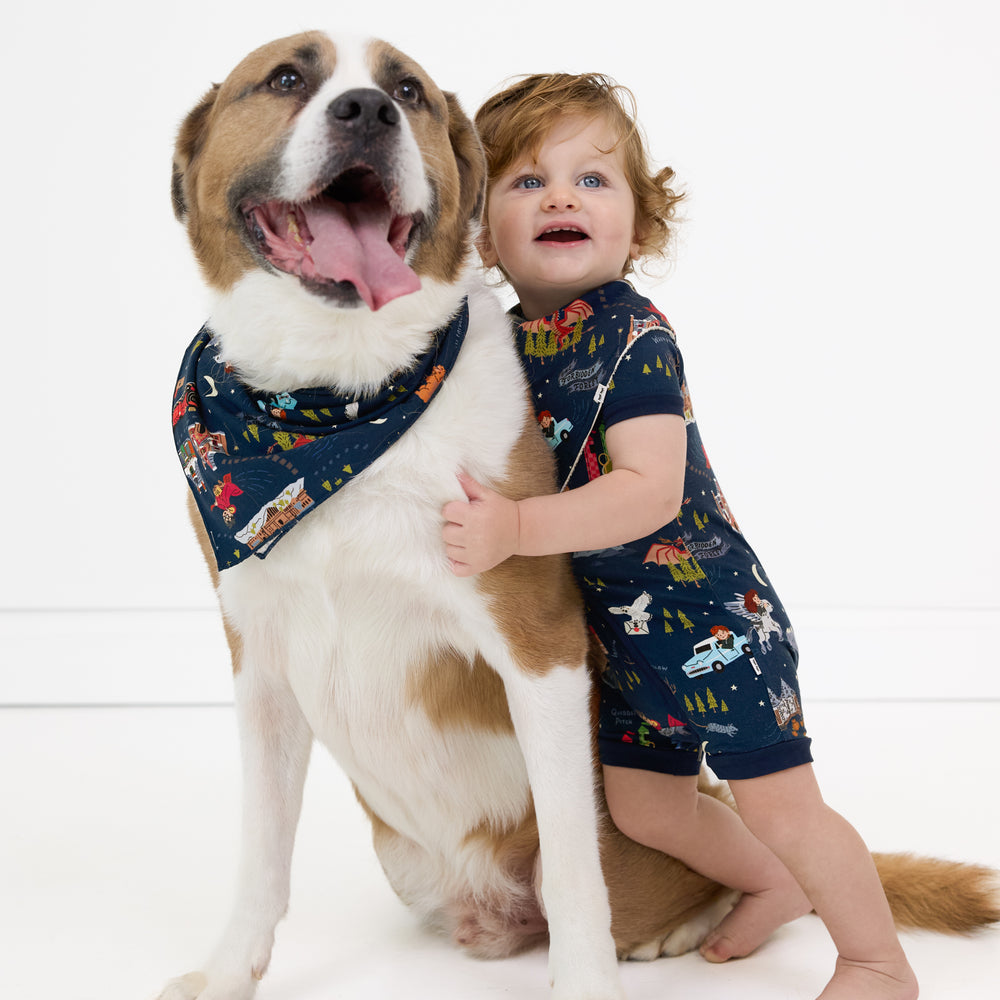 Image of a child and their dog wearing matching an Evening at Hogwarts printed shorty zippy and pet bandana 