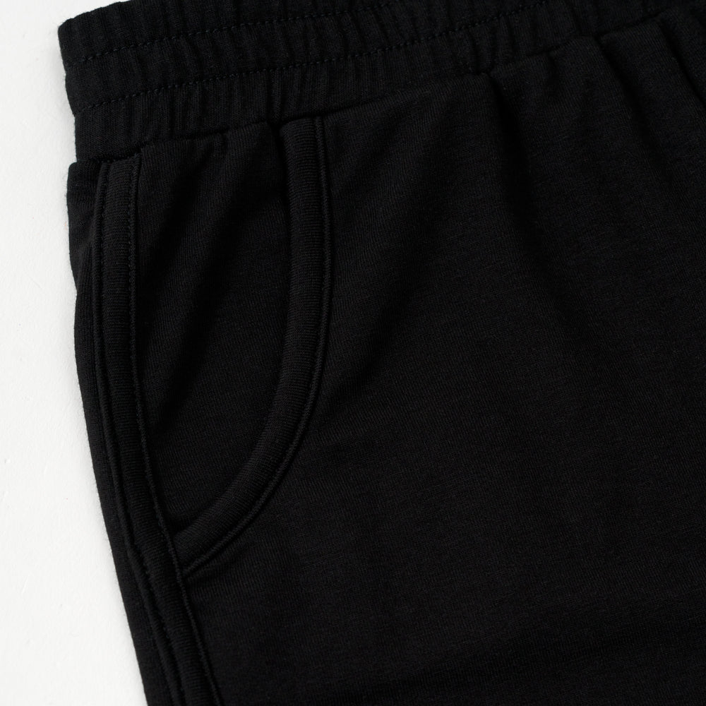 Flat lay image of the pocket detail on the Black Dolphin Shorts