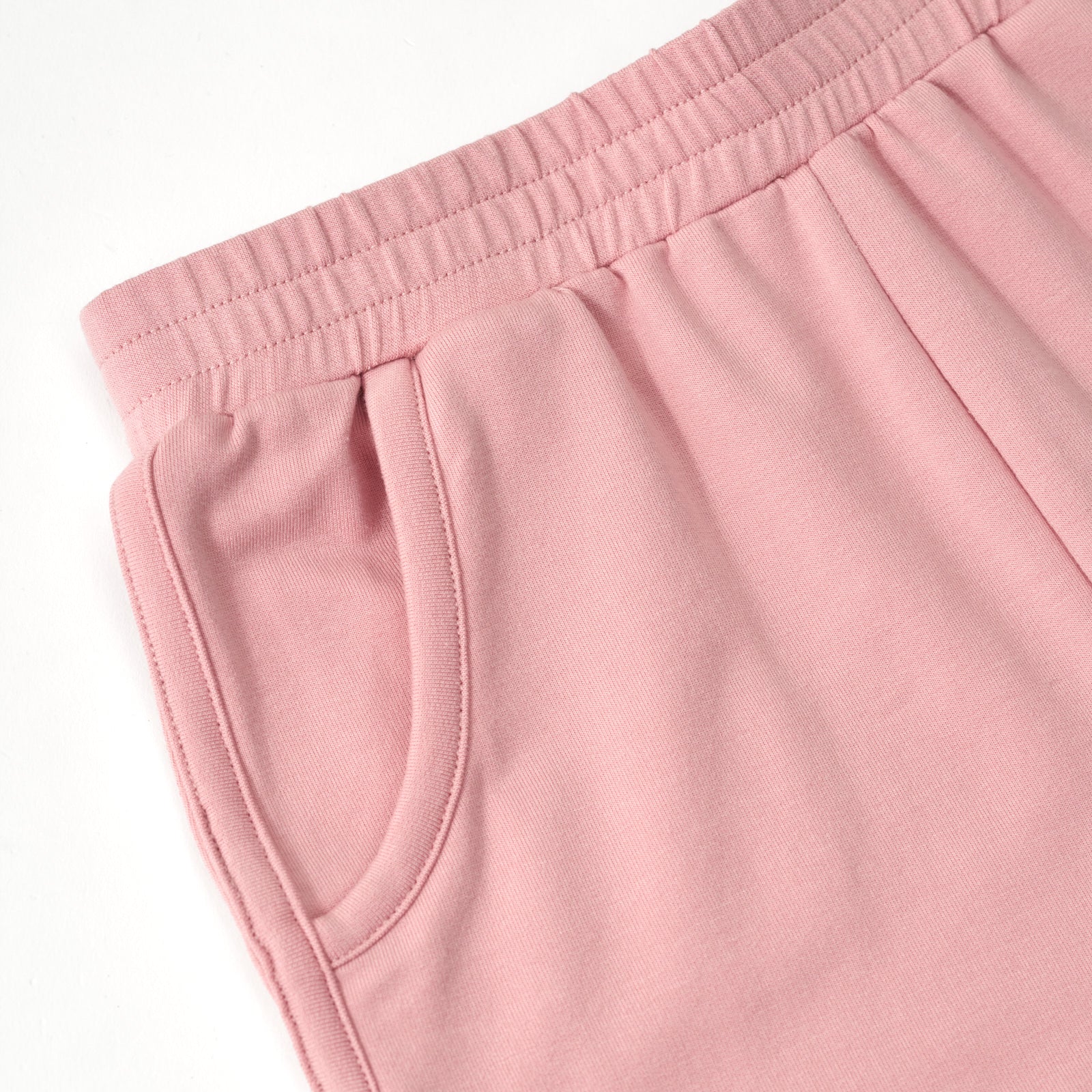 Close up flat lay image of the pocket detail on the Mauve Blush Dolphin Shorts