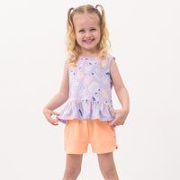 Child wearing Peach Nectar dolphin shorts and coordinating Play top