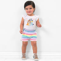 Child wearing Rainbow Stripes dolphin shorts and coordinating top