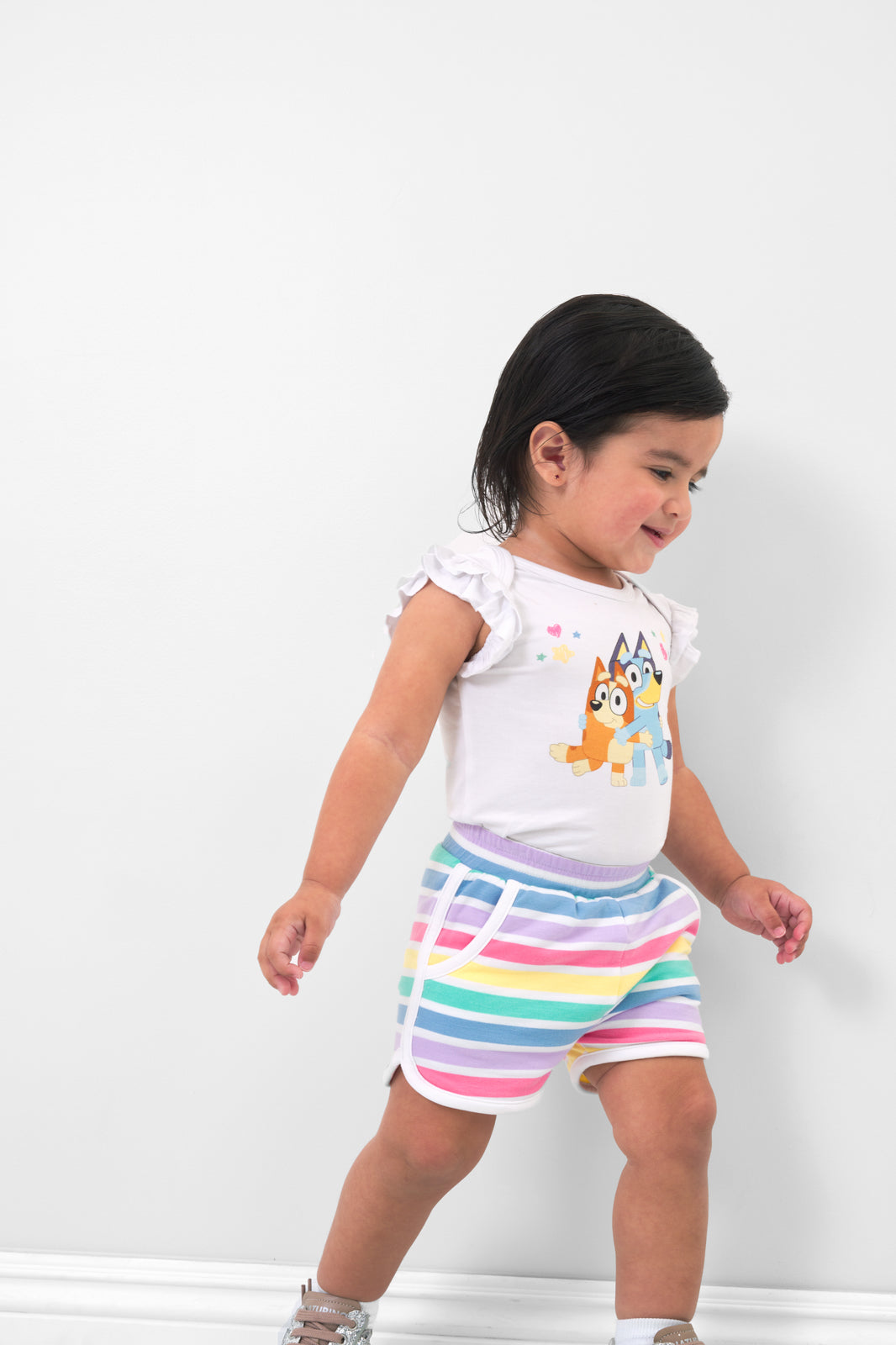 Girl wearing the Rainbow Stripes Dolphin Shorts