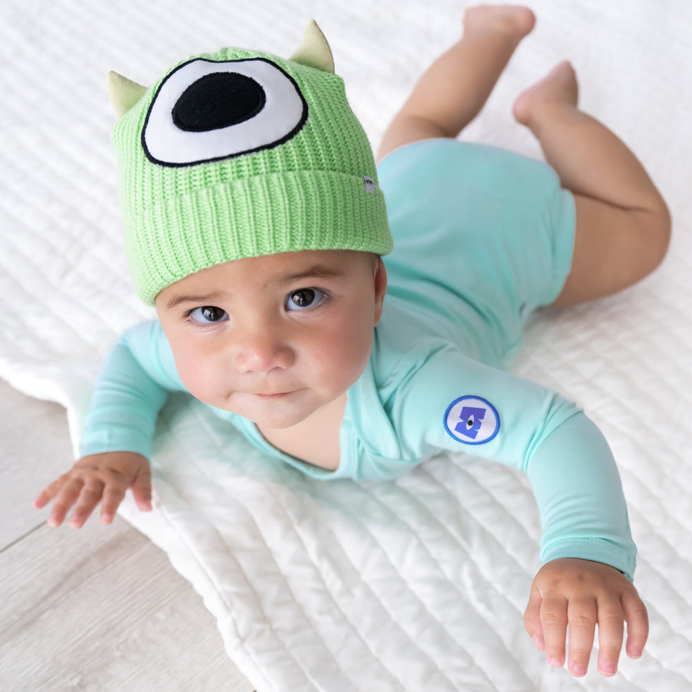 Top view image of baby laying down while in the Disney Monsters, Inc. Mike Wazowski Beanie Hat