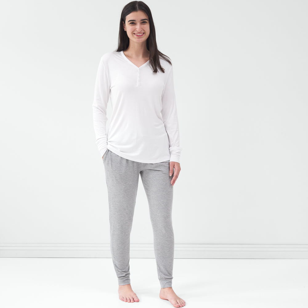 Standing woman wearing the Bright White Women's Pajama Top with gray pajama pants