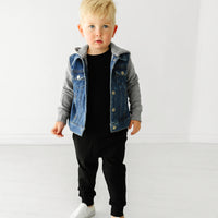Child wearing Black joggers and coordinating Play top and jacket