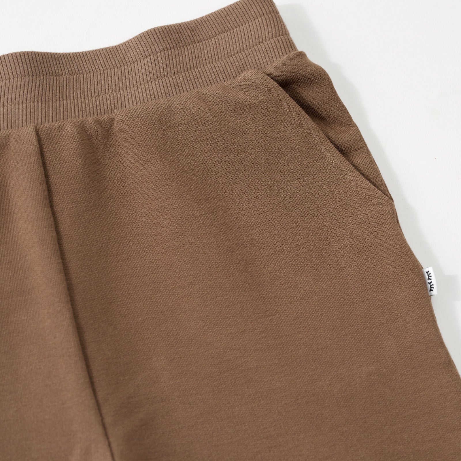 Close up flat lay image of the waist and side pocket detail on the Vintage Brown Jogger 