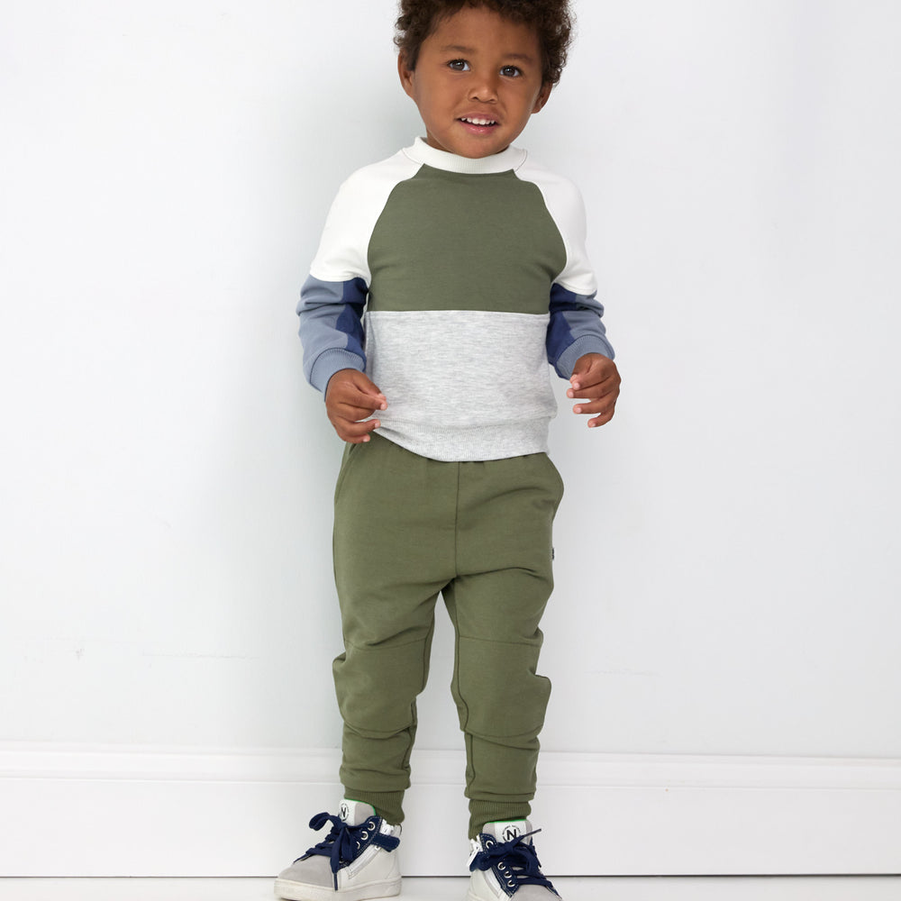 Image of a child wearing Olive Joggers and a coordinating Panel Crewneck