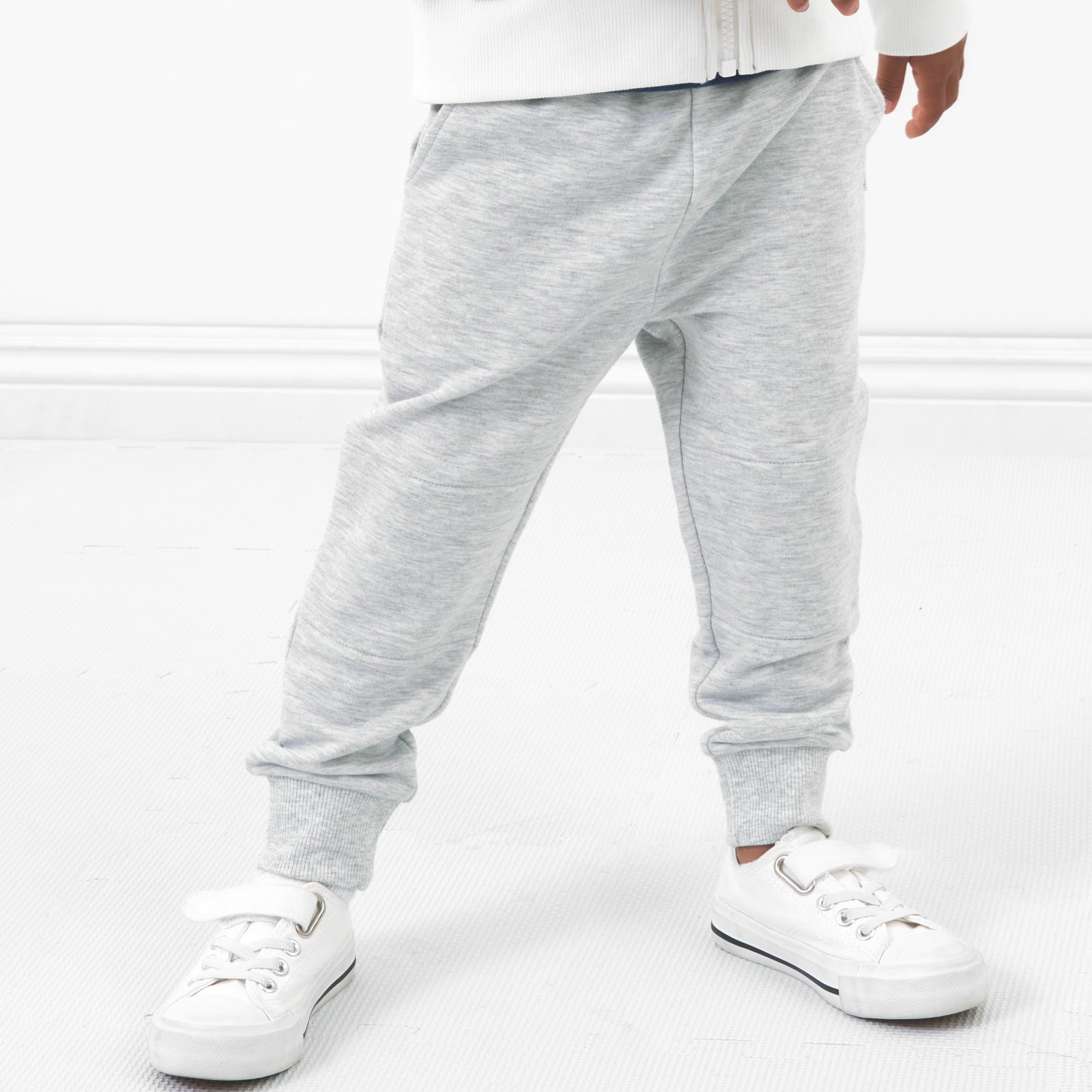 Close up image of a child posing wearing Light Heather Gray joggers