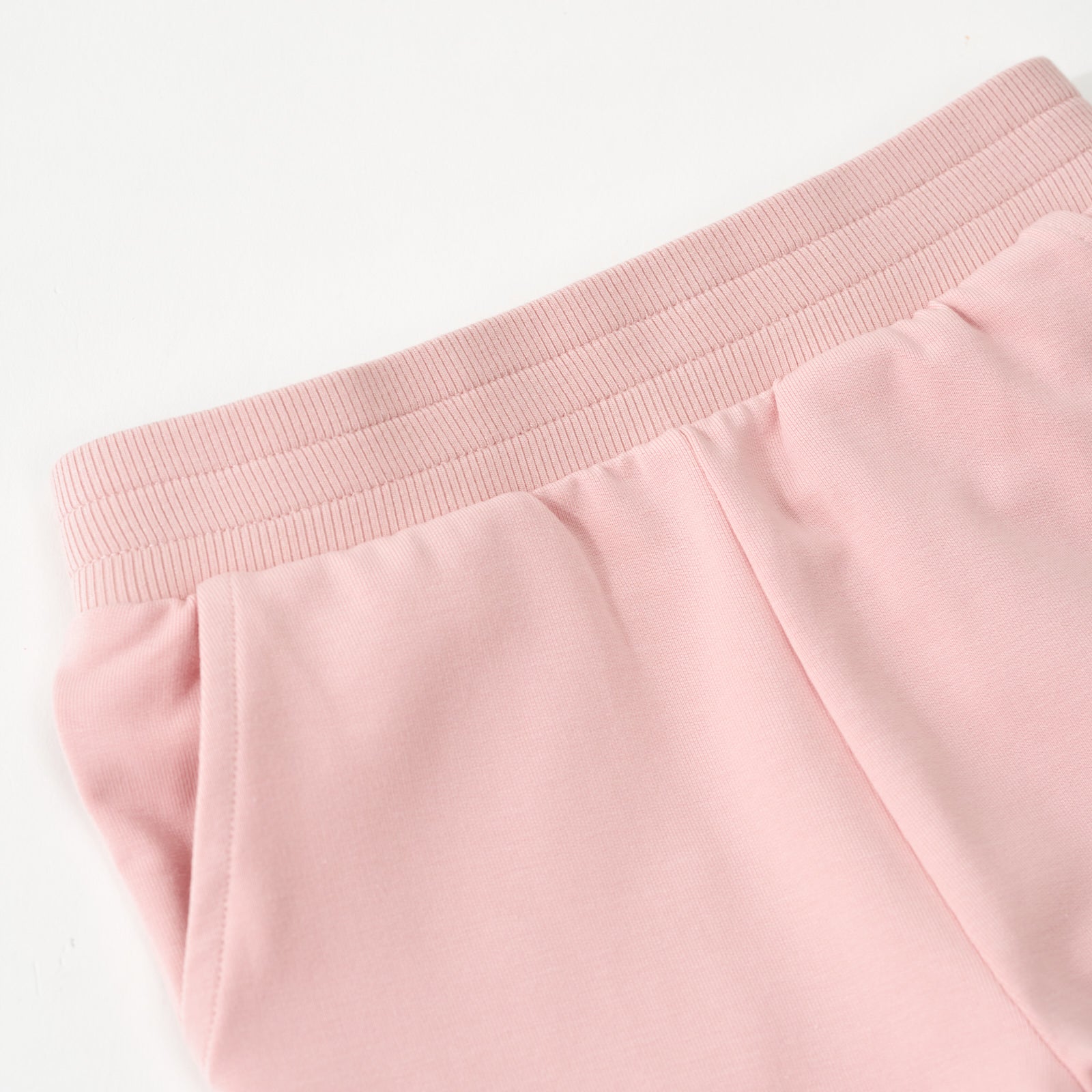 Close up flat lay image of the wrist and pocket detail on the Mauve Blush Jogger